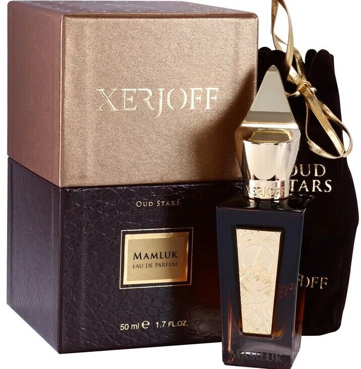 Xerjoff Mamluk Review Perfume bottle placed among other luxury fragrances in a collection.